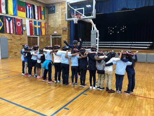 A second grade class after having their free bike helmets fit by a certified instructor. 