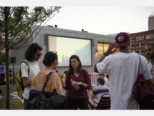 Group of people having a conversation outdoors.