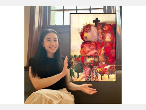 In this photomontage, a smiling young woman gestures toward a painting that appears to be floating. She sits on a bench below a window. The painting incorporates broad strokes of mostly red and yellow and shows a heap of ragged bodies, topped by a cross, that nearly crowds out a view of houses and trees.