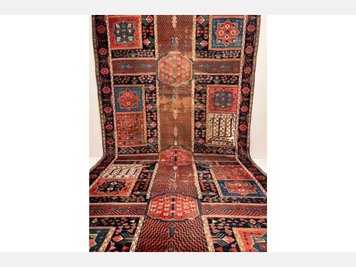 A red carpet with a garden design features water channels, fish, trees, and flowers.