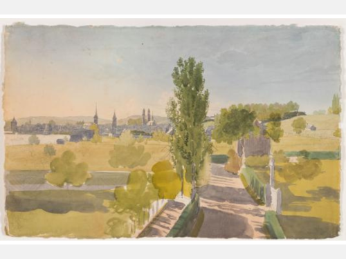 Across light-filled fields and a tree-lined street, a city is visible from the distance, framed by a lake and rolling hills. 