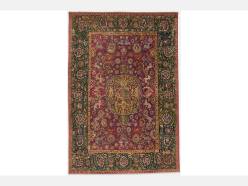 A red carpet with a garden design featuring animals and flowers.