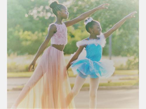 Photo of two children dancing.