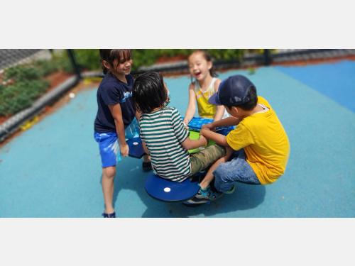 Photo of children at the playground in the School Age Program.