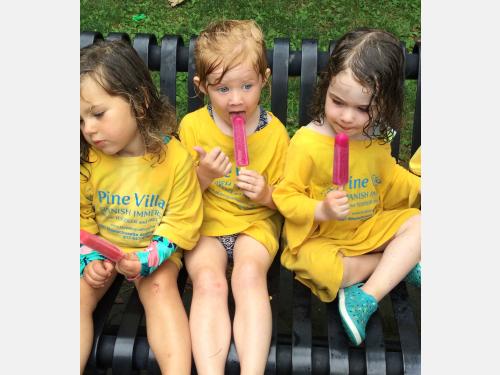 Photo of happy campers eating popsicles.