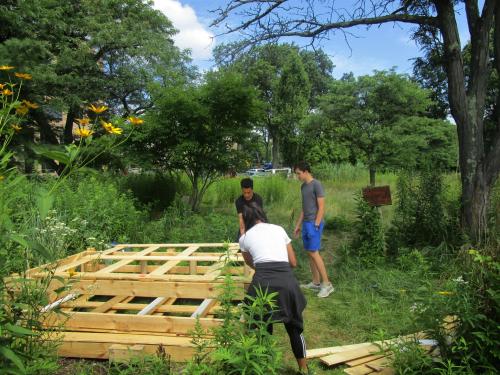 Photo of students building outside with Alewife Ecology as part of the Mayor's Summer Youth Employment Program.