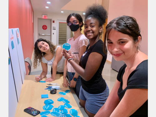 Photo of smiling camp participants working on a group activity.