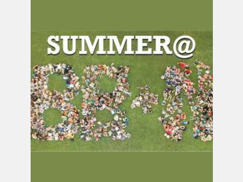Photo of "Summer at BB and N" written from a birds-eye-view of a group of people standing in the shape of letters.