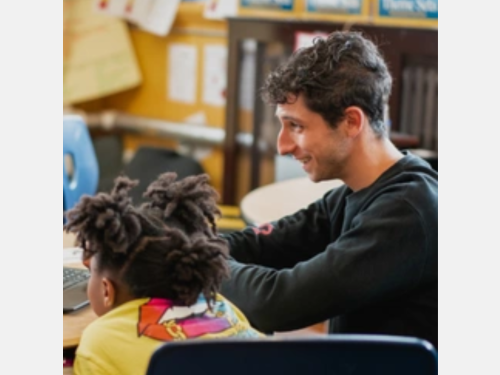 Photo of an instructor from Boston Music Production working with a child.